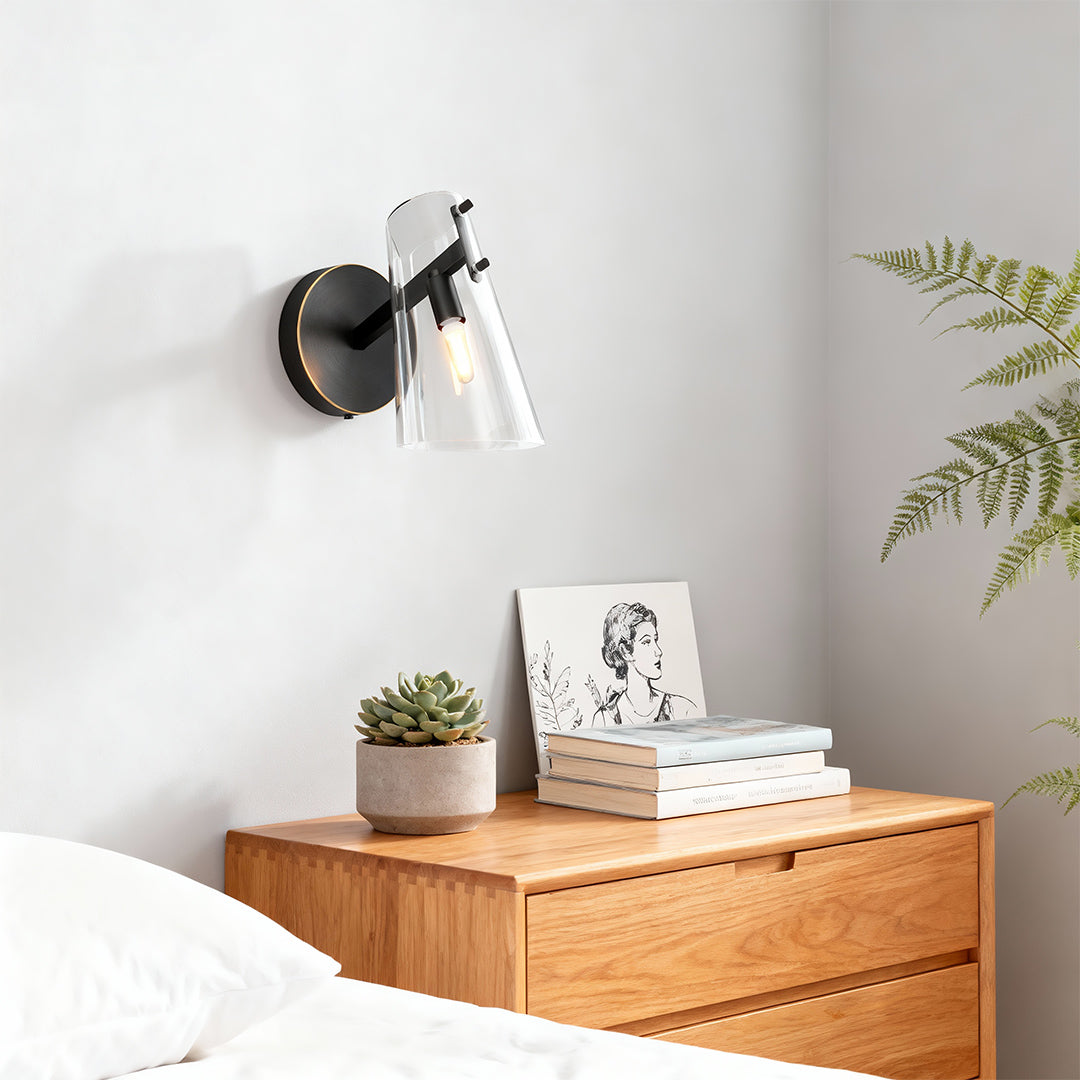 Contemporary wall sconce lighting illuminating minimalist entryway with wooden console table.
