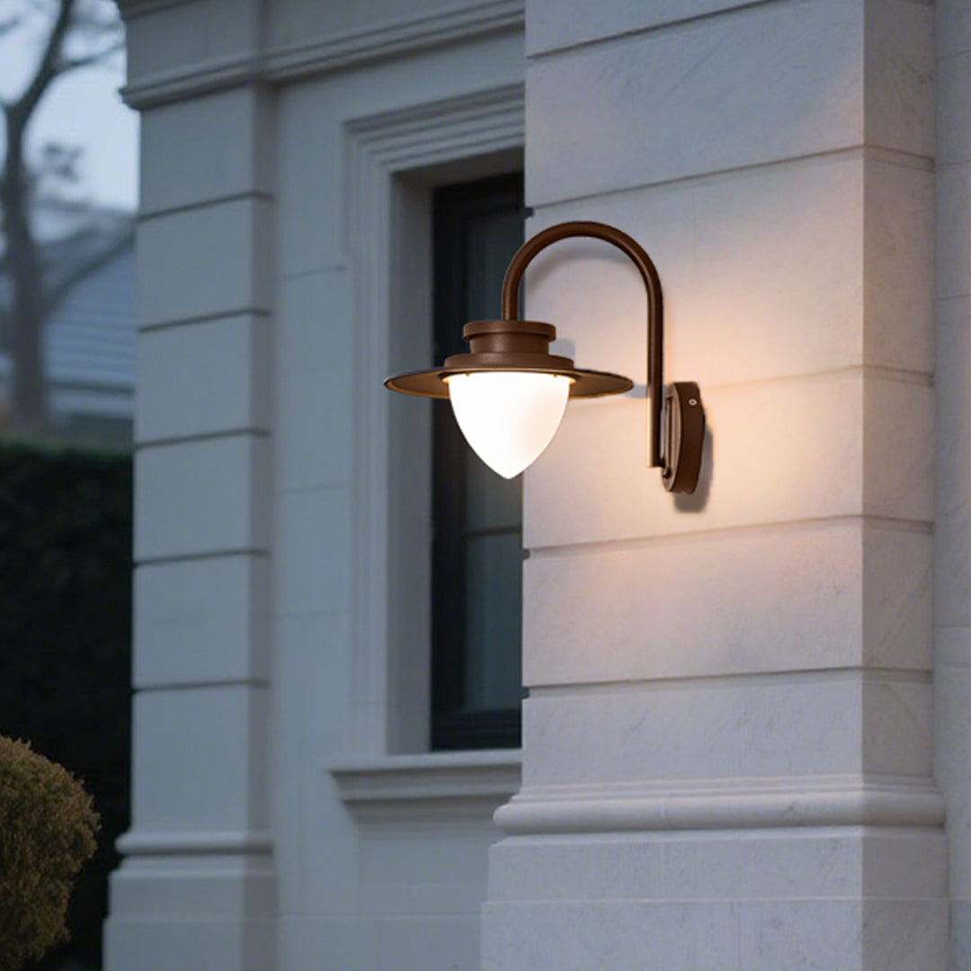 Contemporary wall sconce casting warm downward light on textured stone wall surface