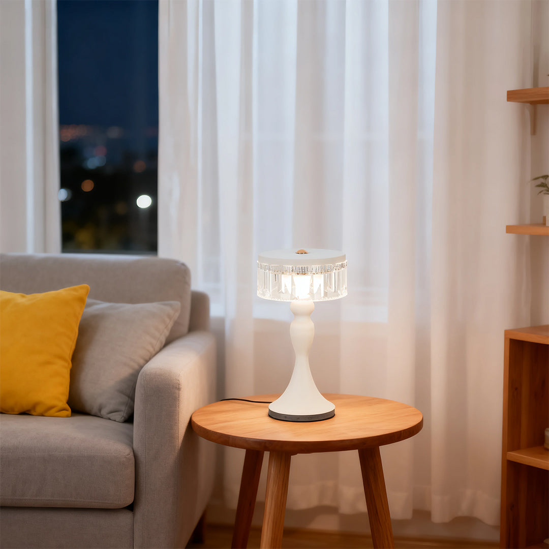 Contemporary white forged iron table lamps style enhancing the cozy living room ambiance next to a yellow pillow.