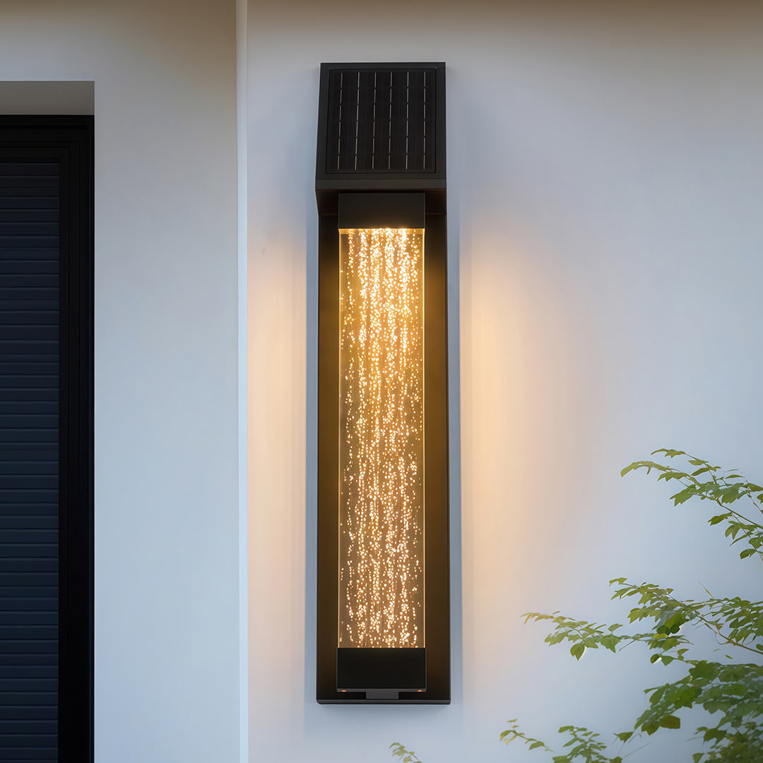 Black outdoor lighting sconce with a textured glass panel, installed on a white wall for a contemporary look.