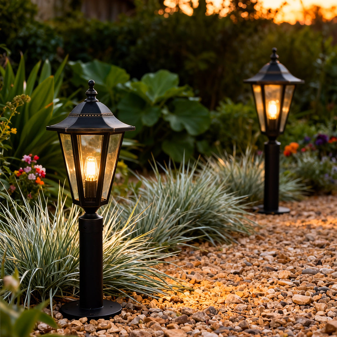 Copper landscape path lights placed beside a landscaped garden trail, adding soft illumination and a timeless outdoor look.