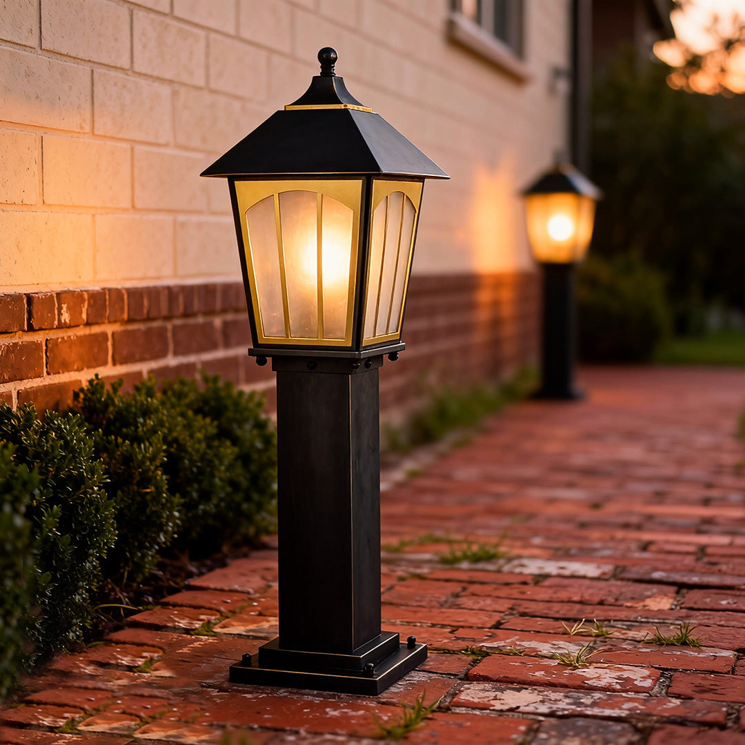 Copper LED path lights illuminating a brick pathway, adding warm light and timeless character to the outdoor space.