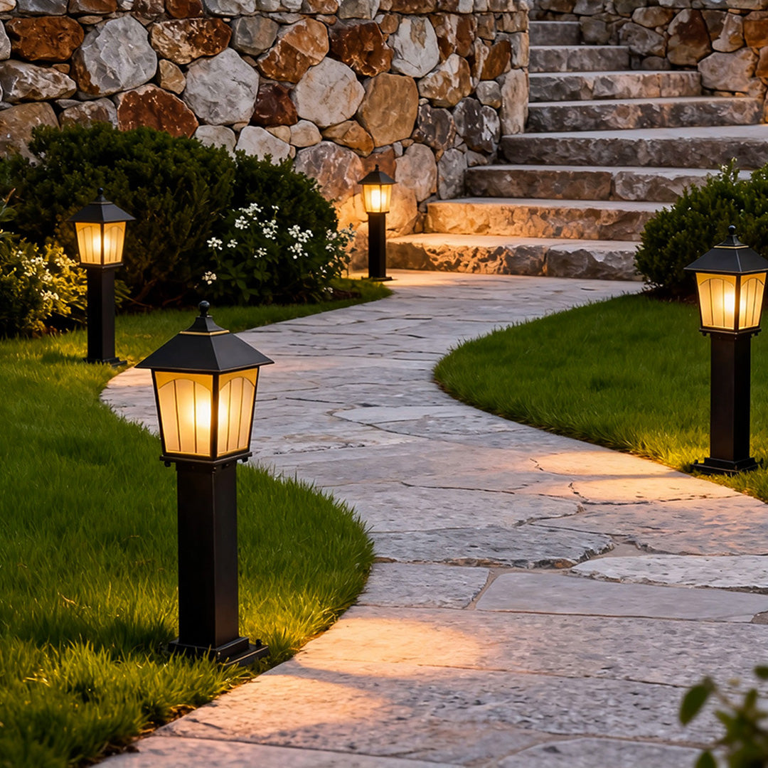 Copper LED path lights lining a curved stone walkway, creating a welcoming and softly lit outdoor pathway.