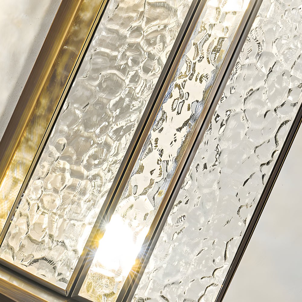 Close-up of copper outdoor wall lantern glass panels showing detailed hammered texture and warm internal lighting.