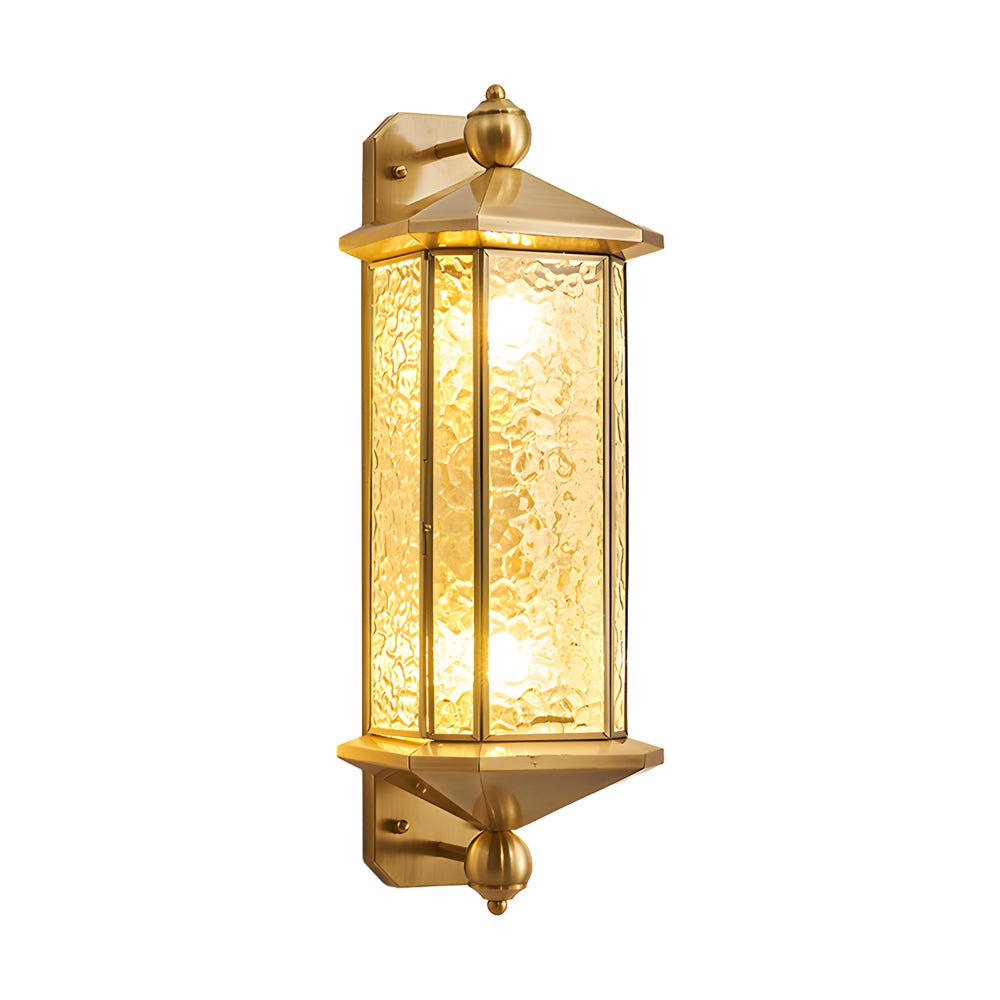 Isolated copper outdoor wall lantern with warm light turned on, emphasizing classic proportions and textured glass.