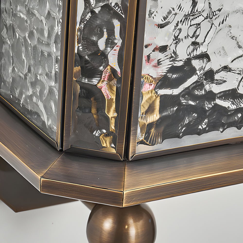 Detailed corner view of a copper outdoor wall lantern base, showcasing refined metal edges and textured glass panels.