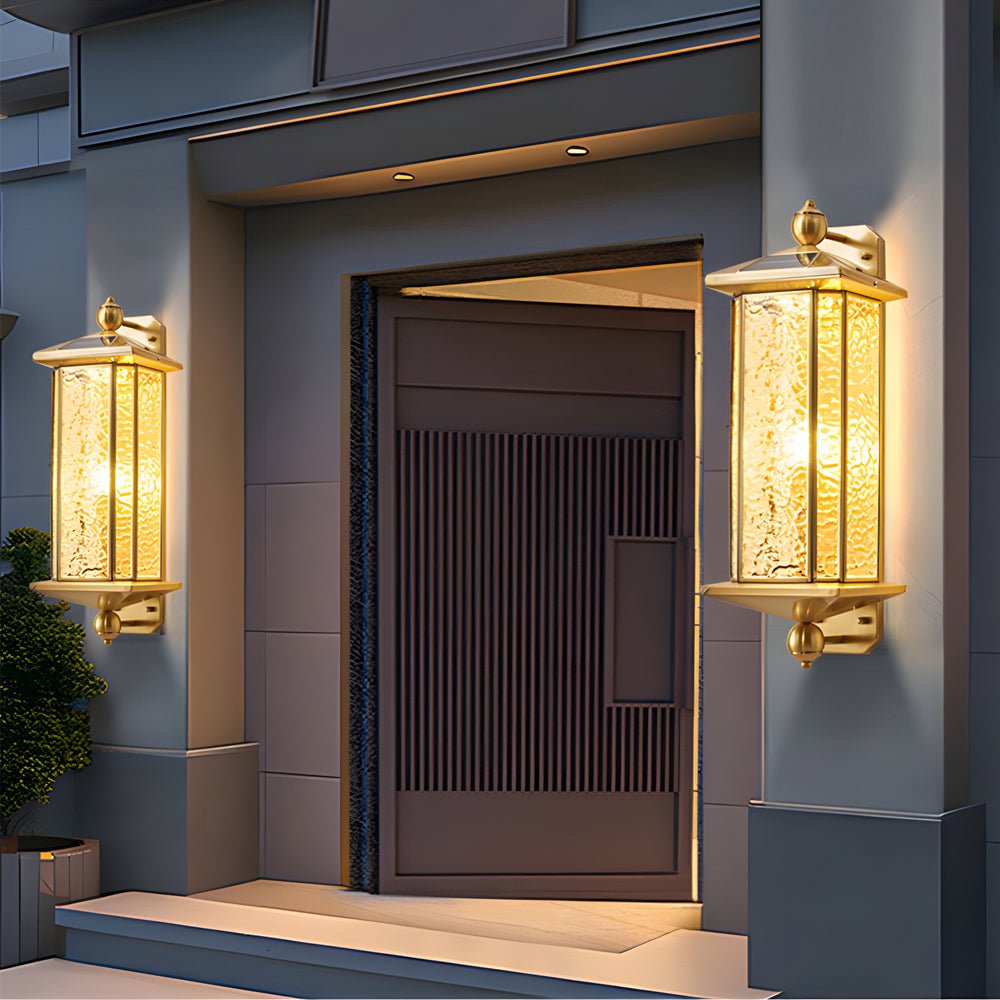 Copper outdoor wall lanterns flanking a modern entrance, providing warm and elegant illumination for the doorway.