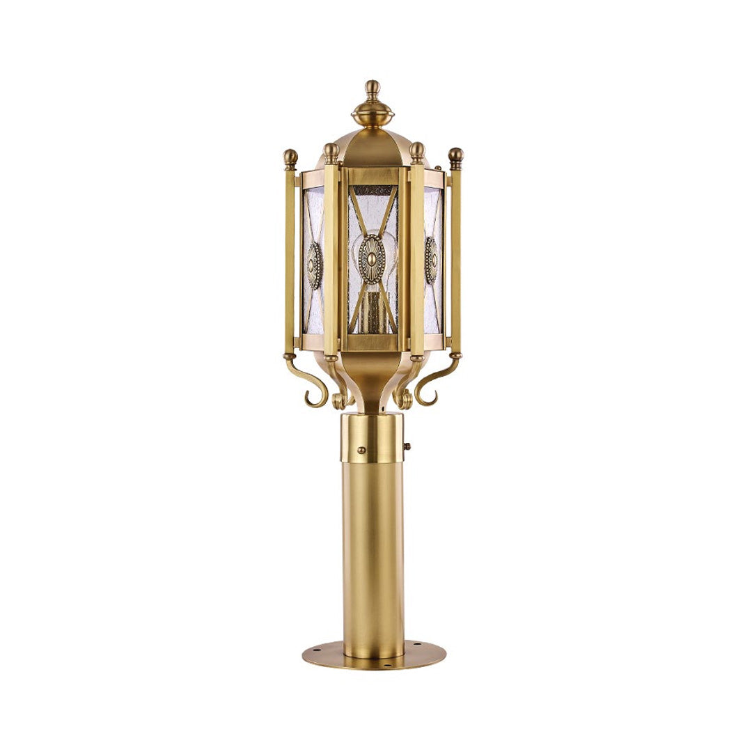 Copper path light illuminating a stone walkway at dusk, creating a warm and inviting ambiance in the garden.