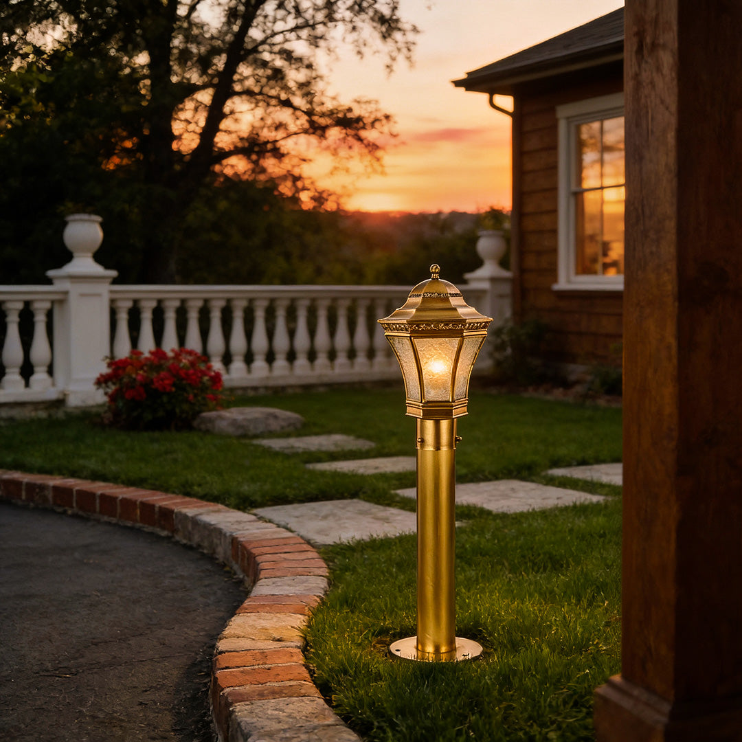 Copper path lights installed along a curved garden walkway at sunset, providing warm illumination and classic outdoor charm.