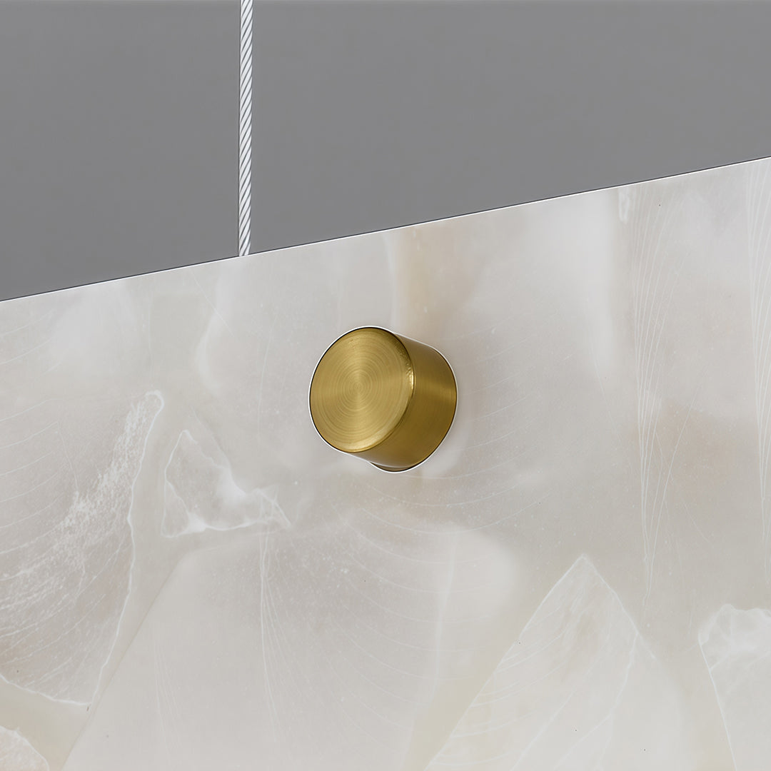 Copper metal pendant light with a circular gold detail, emphasizing modern and luxurious design