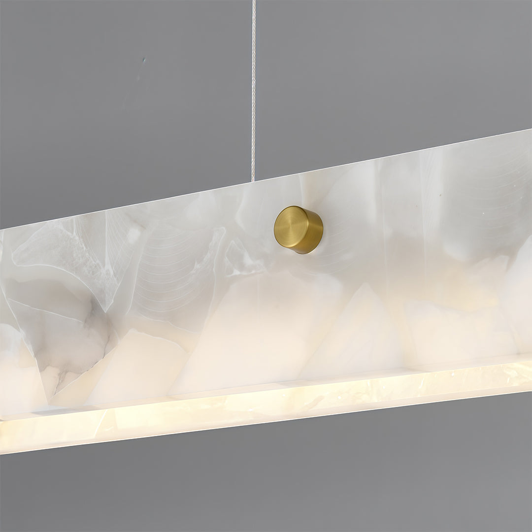 Copper metal pendant light with a circular gold detail, emphasizing modern and luxurious design