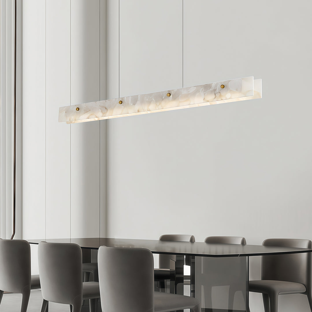Copper metal pendant light with a marble detail, enhancing the ambiance of a sophisticated dining space