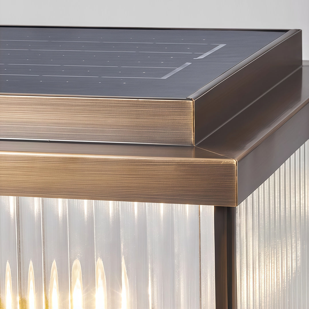 Detail shot of copper pillar light corner revealing layered construction and warm wooden base trim