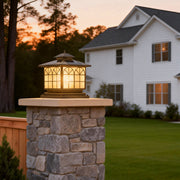 Copper pillar lights illuminating a classic house exterior with warm, inviting glow.