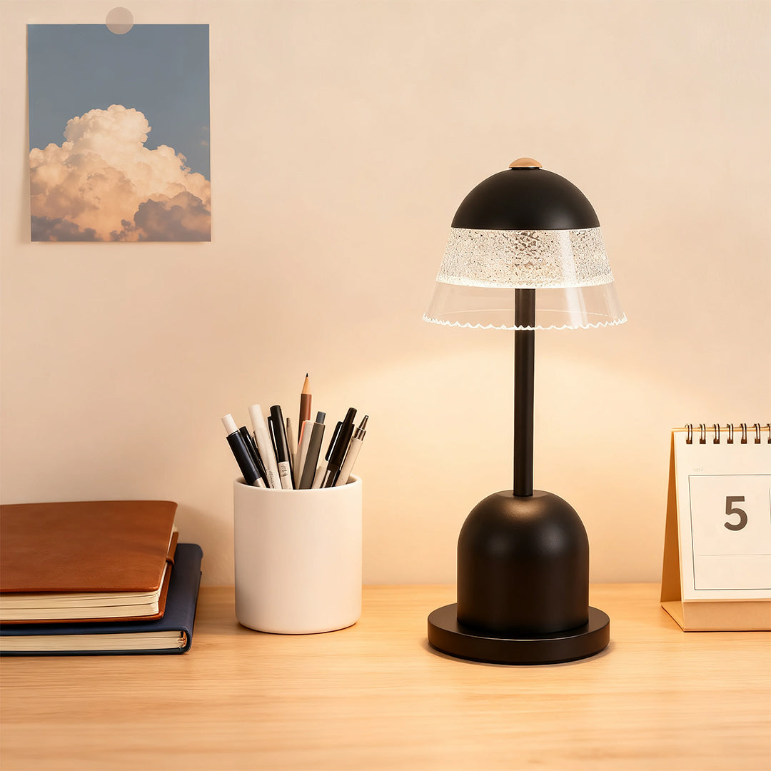Cordless black USB table lamps with a clear mushroom shade used for task lighting on a wooden desk.