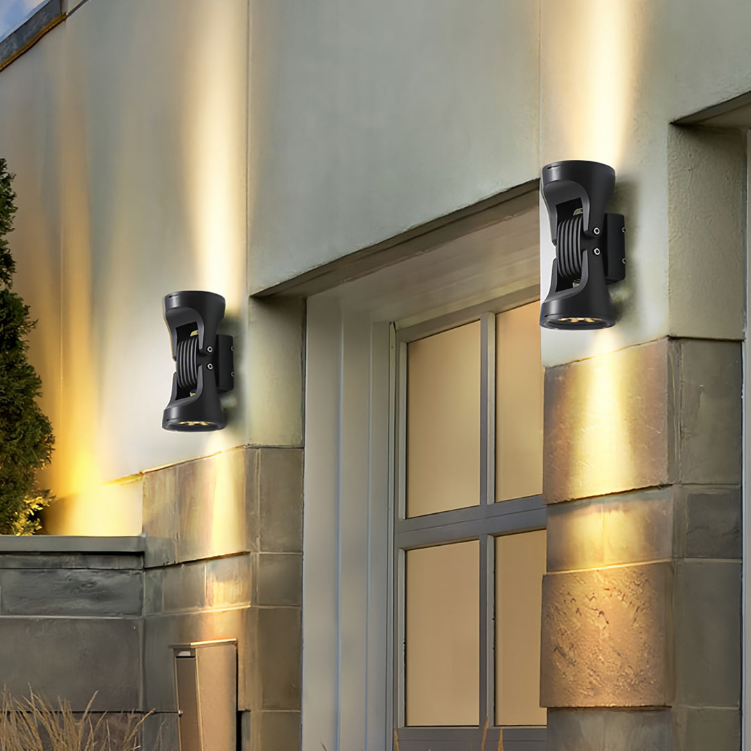 Warm glowing two light wall sconce illuminating a modern corridor with ambient up-down lighting.