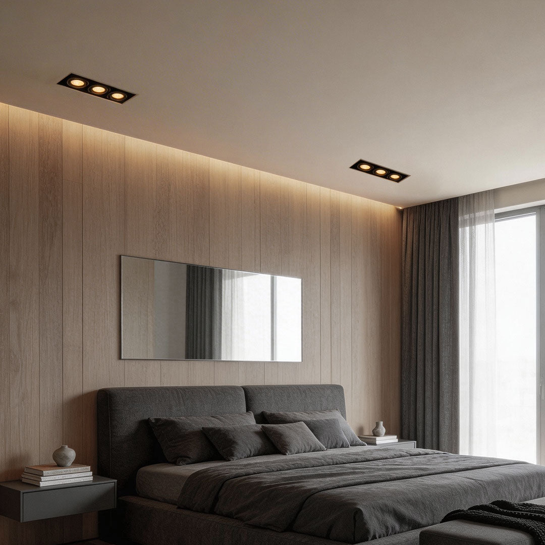 Cozy bedroom with wood panel wall and led spotlight indoor accent lighting over bed area.