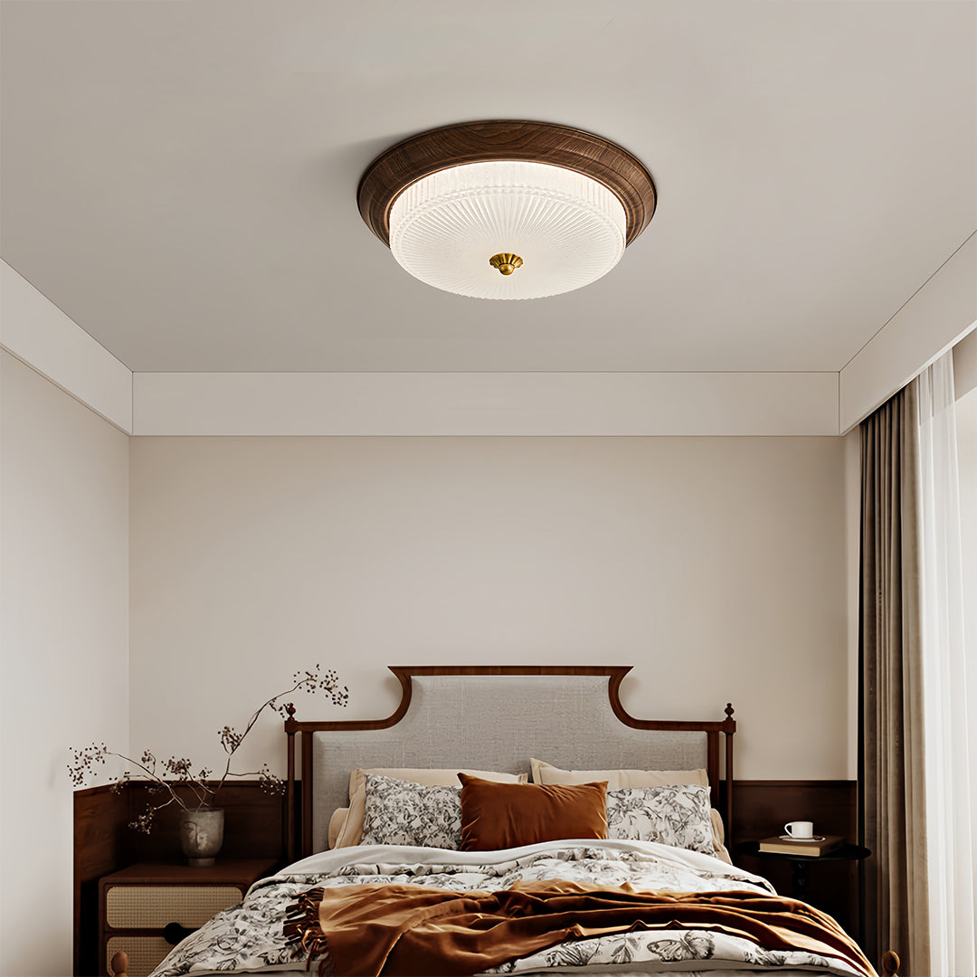 Cozy bedroom featuring vintage art deco flush mount ceiling light, classic and warm lighting