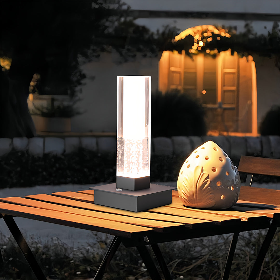 Cozy reading area with small black pendant light creating warm ambient glow from crystal elements