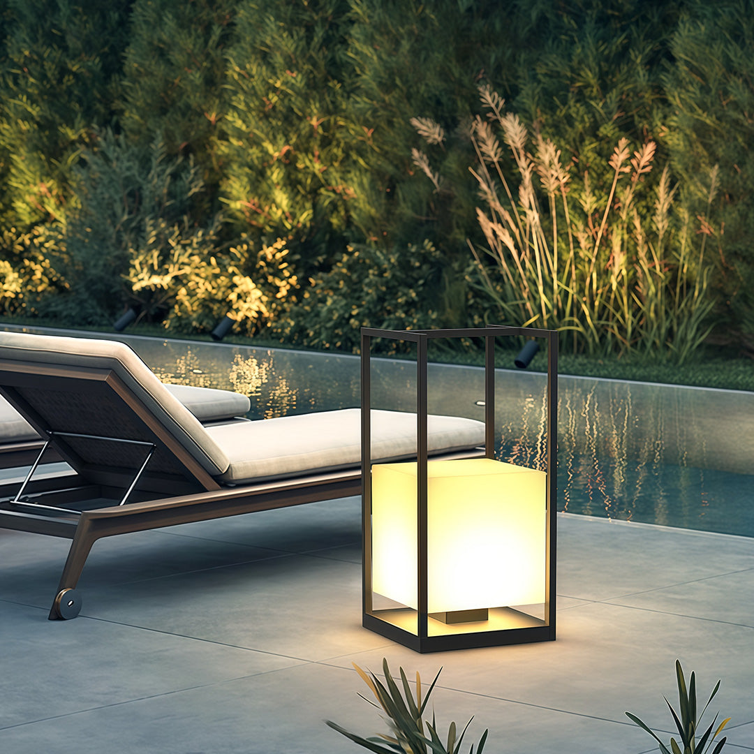 Contemporary outdoor lantern illuminating a garden pathway, creating a cozy and inviting atmosphere.