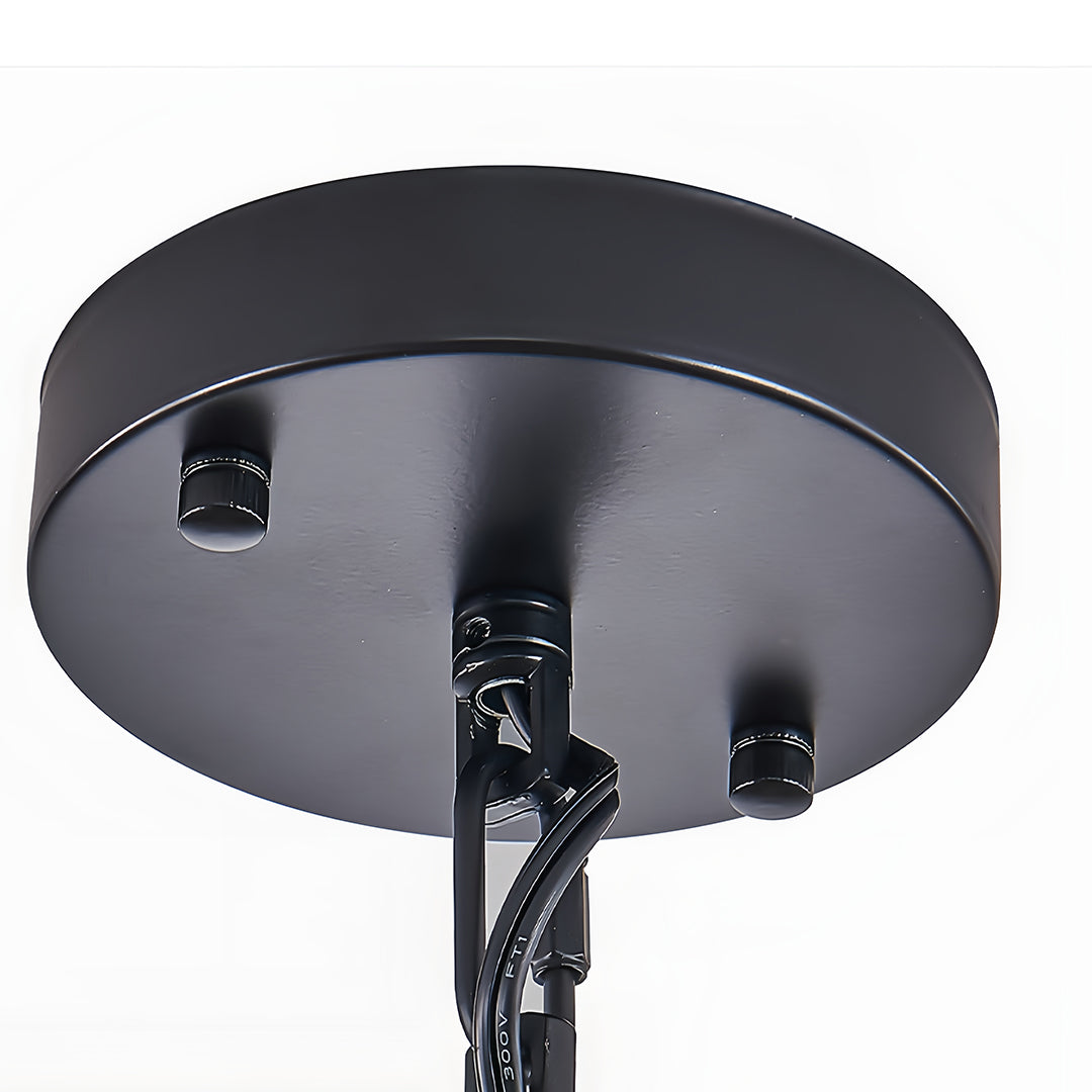 Black drum pendant light in a cozy kitchen, enhancing the space with its unique industrial design.