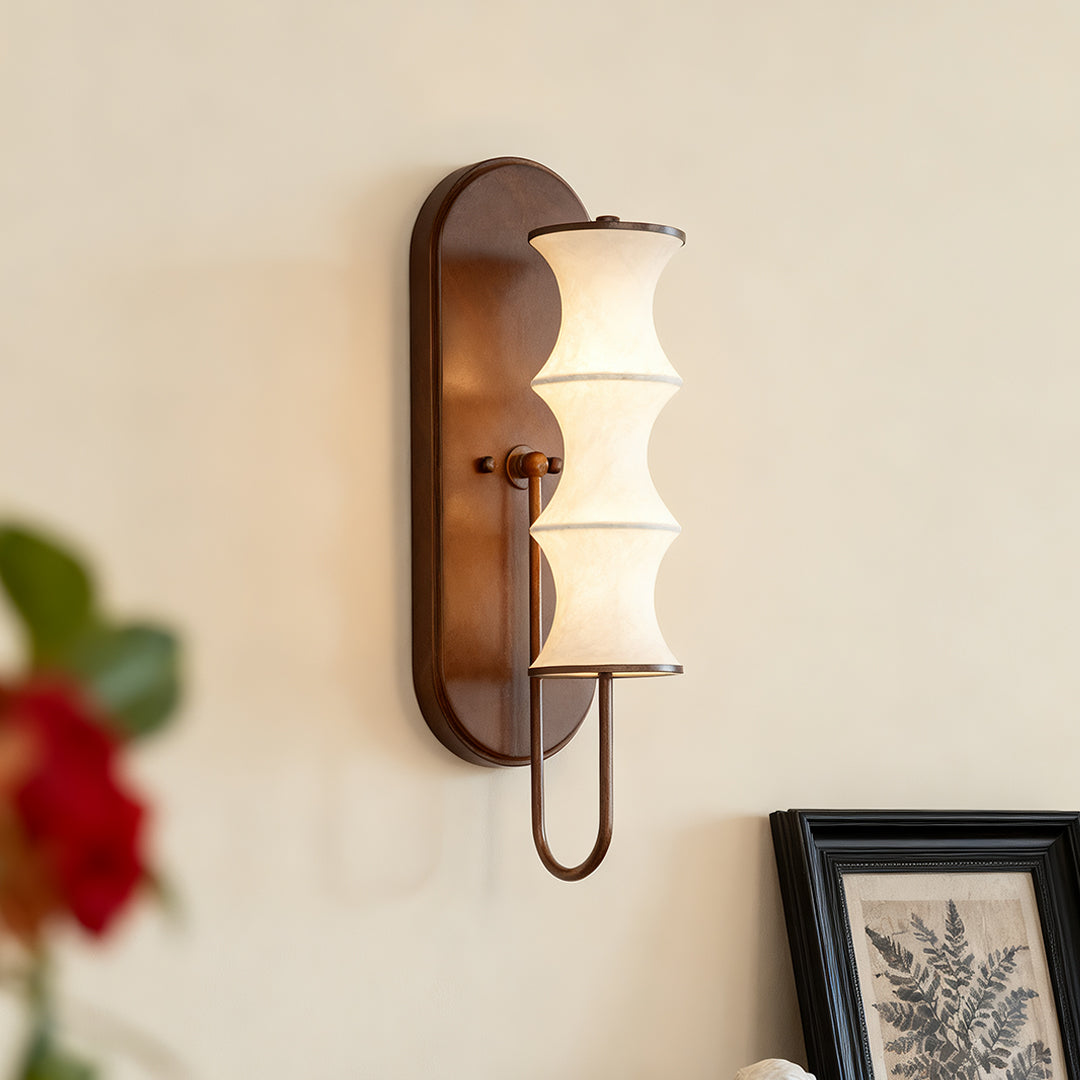 Modern triple cylindrical vintage French wall lights with white glass shades in a contemporary hallway