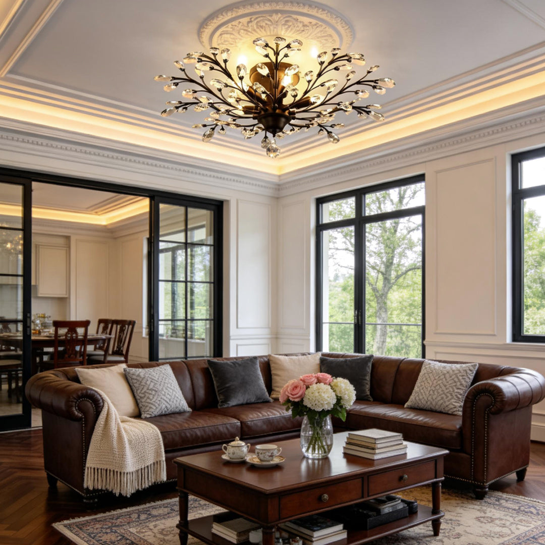 Crystal branch chandelier installed in luxury living room with tray ceiling.