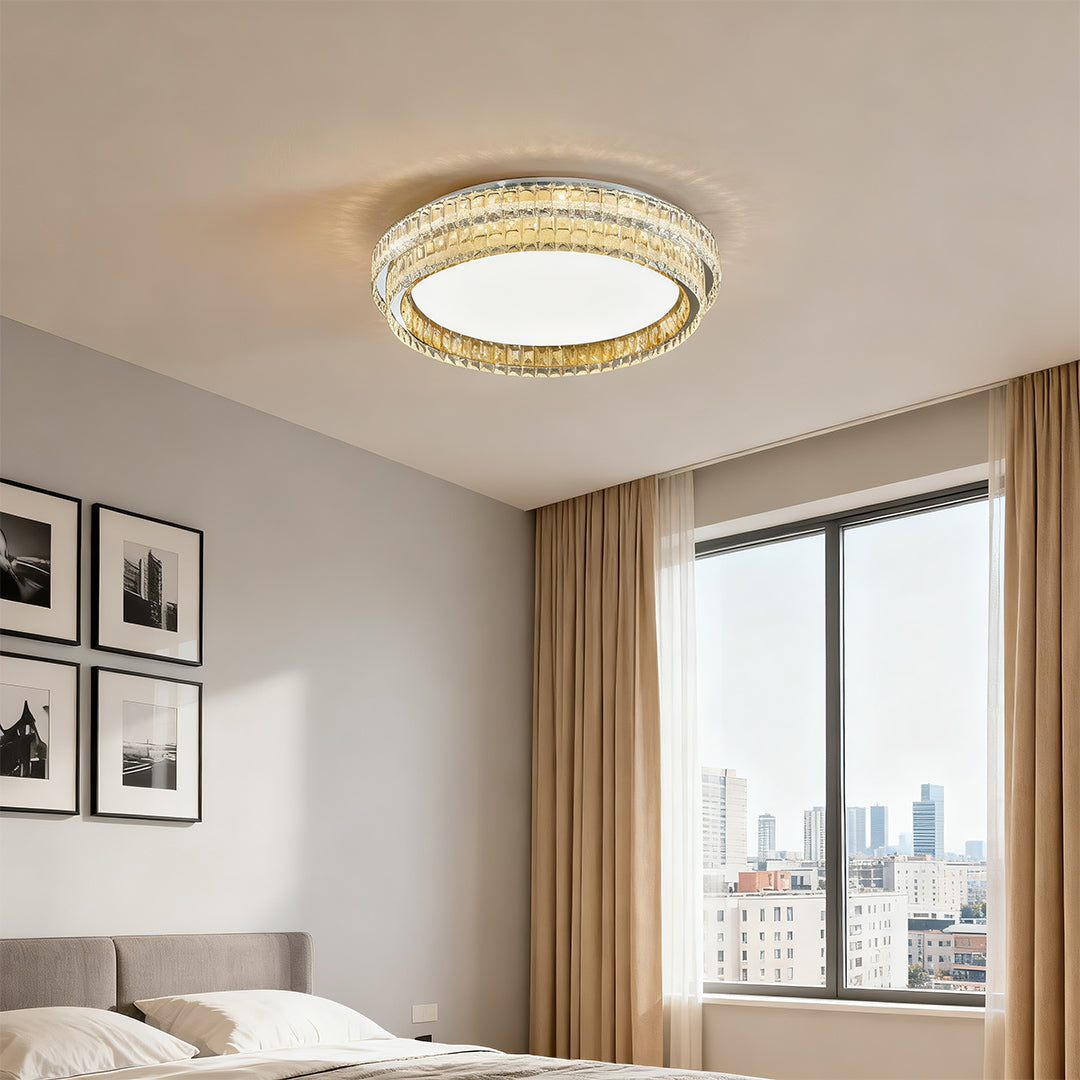 Crystal ceiling light providing warm illumination in a modern bedroom setting.