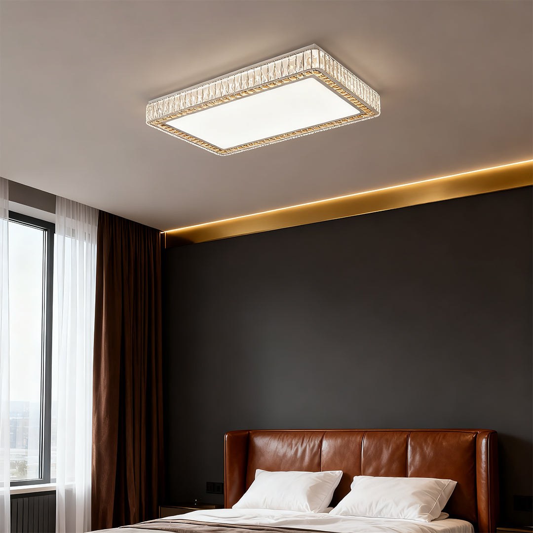 Modern crystal ceiling light glowing above a cozy bedroom with dark accent wall.