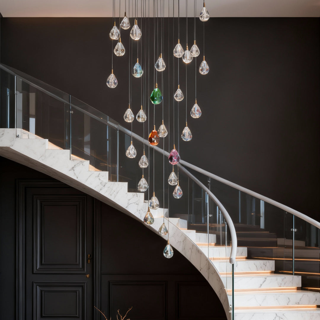 Crystal chandelier for staircase descending along dramatic black staircase with marble steps and contemporary railing design