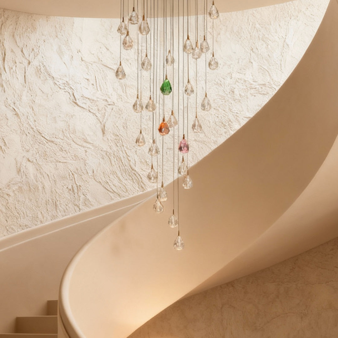 Crystal chandelier for staircase illuminating curved stairwell with warm textured walls creating elegant cascading light effect