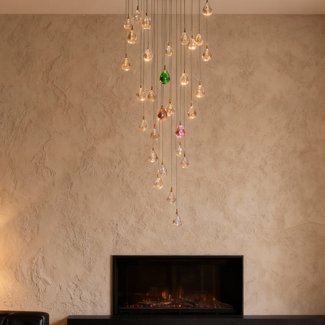 Crystal chandelier for staircase creating focal point against textured beige wall beside modern fireplace in double-height space