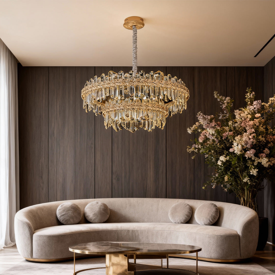 Crystal chandelier lamp over a round dining table with neutral tones.