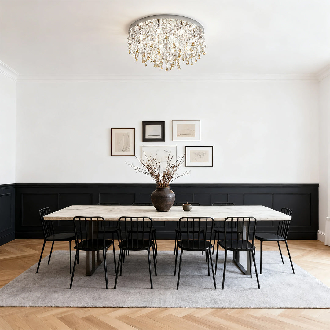 Unique crystal chandelier illuminating modern dining room with black table and minimalist design