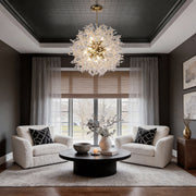 Crystal dandelion chandelier illuminating a modern living room with warm, sparkling glow.