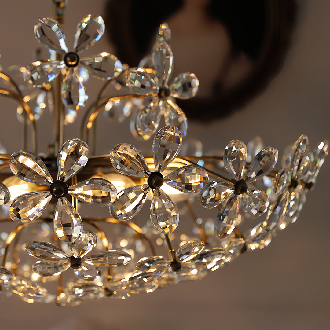 Crystal flower chandelier creating brilliant light reflections with detailed close-up view