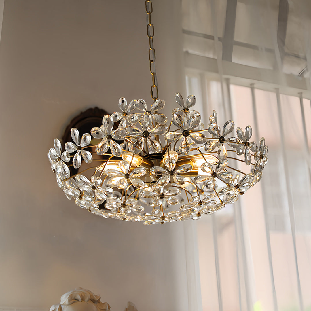 Crystal flower chandelier suspended in bright modern space with natural window lighting