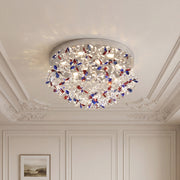 Elegant crystal flush mount lights with vibrant red and blue floral crystals on a chrome base.
