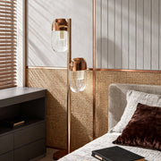 Crystal lamp floor positioned near window in textured bedroom with woven wall panels and natural materials