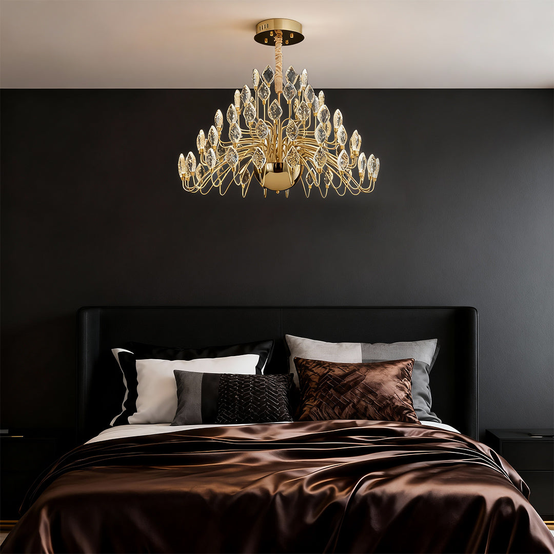 Crystal LED chandelier above a modern bedroom bed.