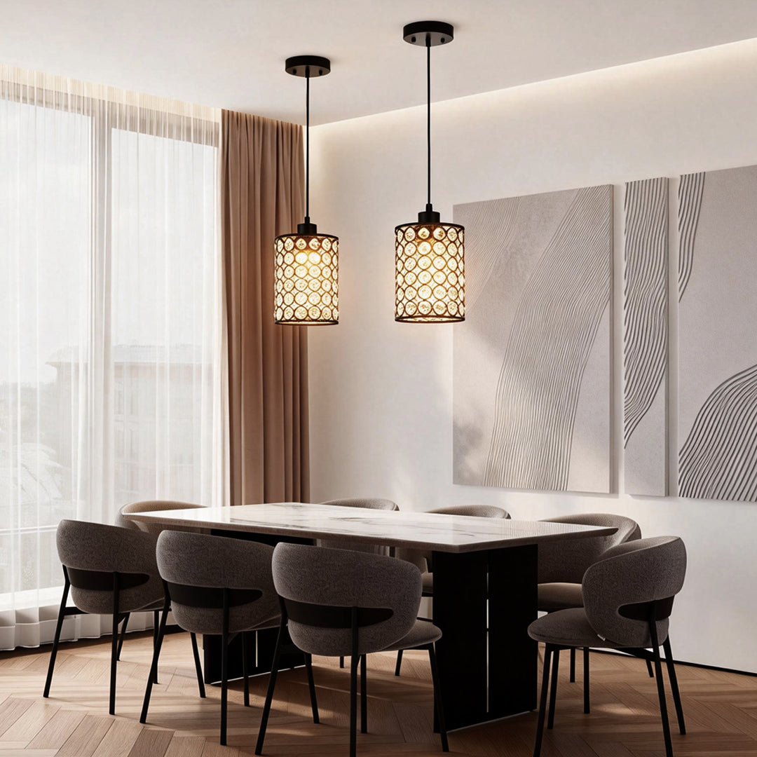 Crystal pendant light set above modern dining table.