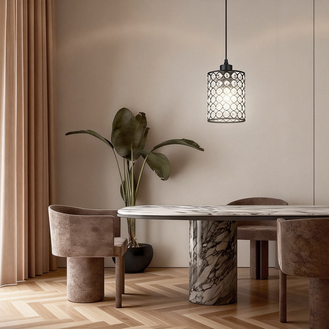 Single crystal pendant light hanging over small dining area.