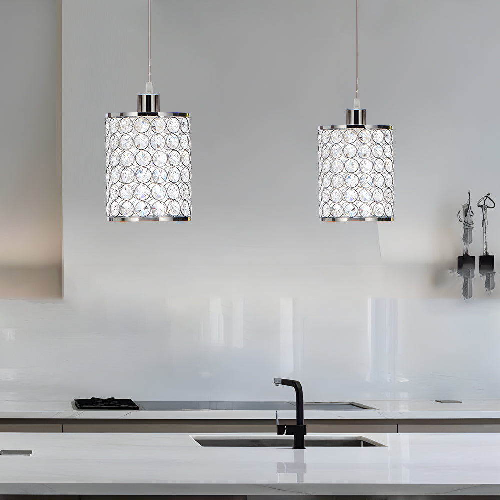 Pair of crystal pendant lights above modern kitchen counter.