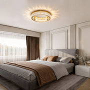 Crystal ring ceiling light illuminating a modern bedroom with soft ambient glow.