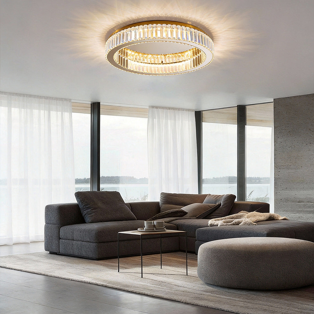 Crystal ring ceiling light installed in a contemporary living room with large windows.