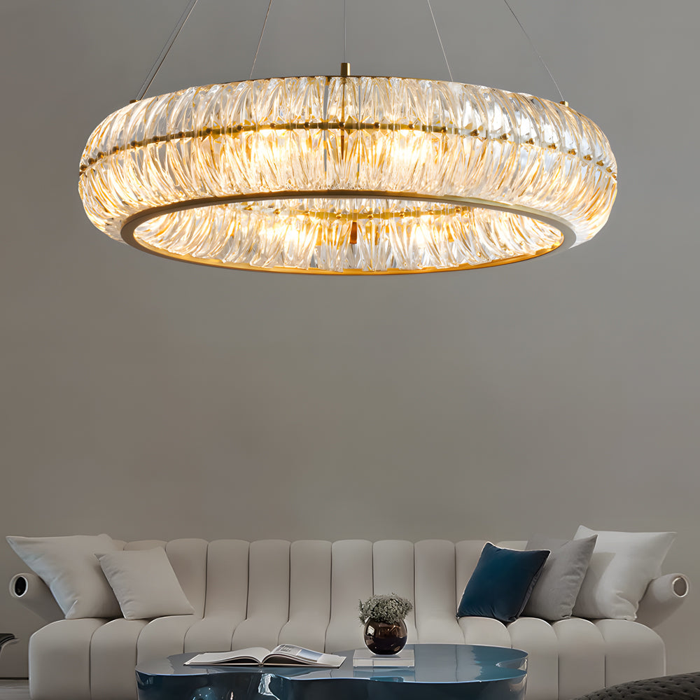 Crystal ring chandelier with a golden finish, illuminating a cozy living room.