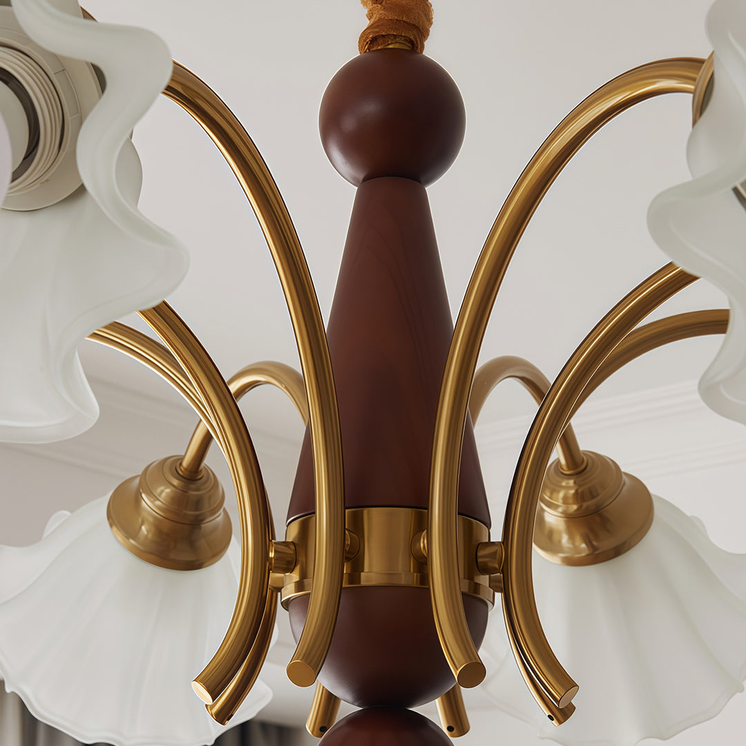 Crystal vintage chandelier installed in bright white bedroom with wall art, neutral bedding, and crown molding.