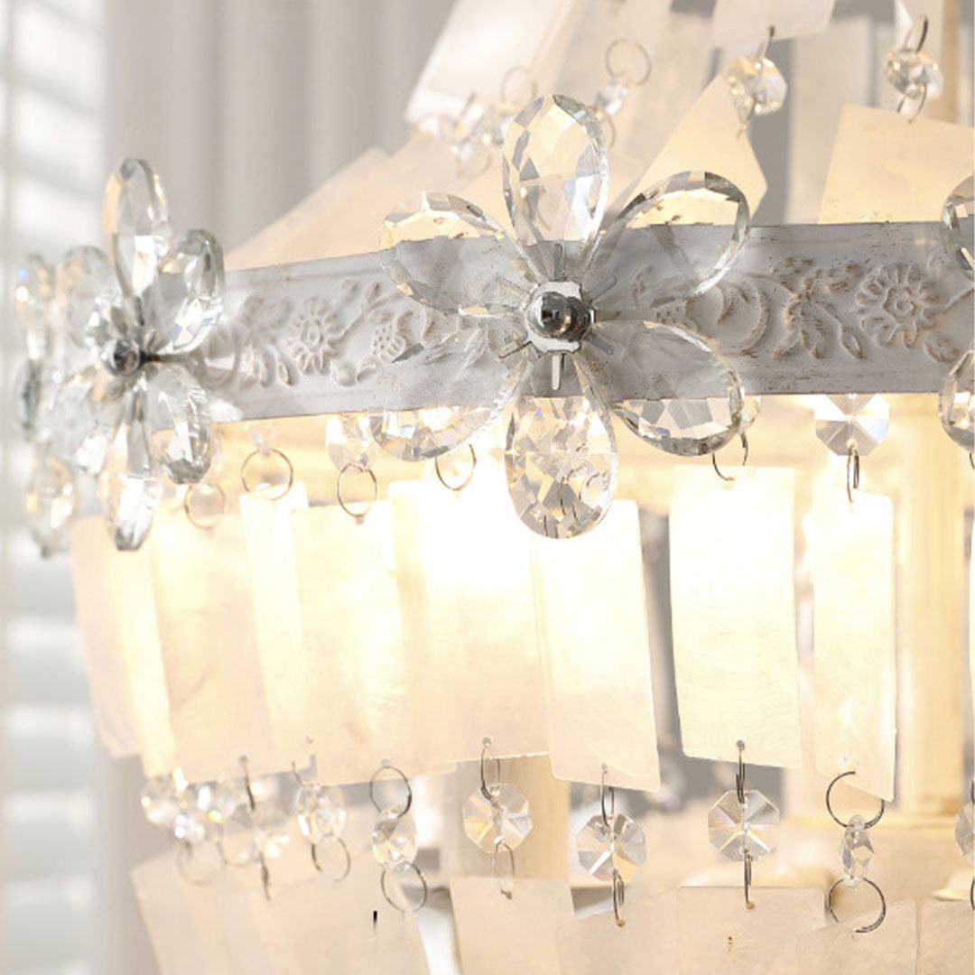 Close-up of crystal vintage chandelier showing floral crystal accents and textured glass panels.