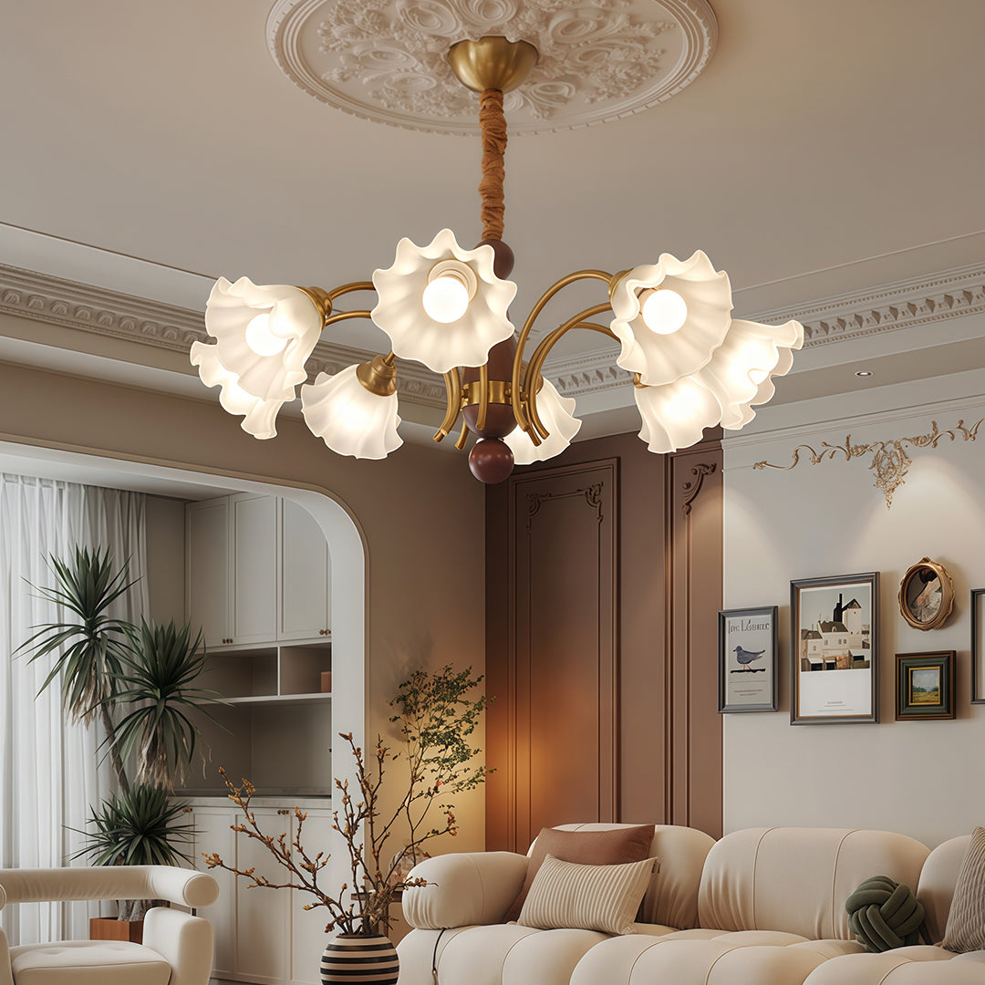 Crystal vintage chandelier brightening elegant dining space with blue curtains, ornate ceiling medallion, and classic furniture.