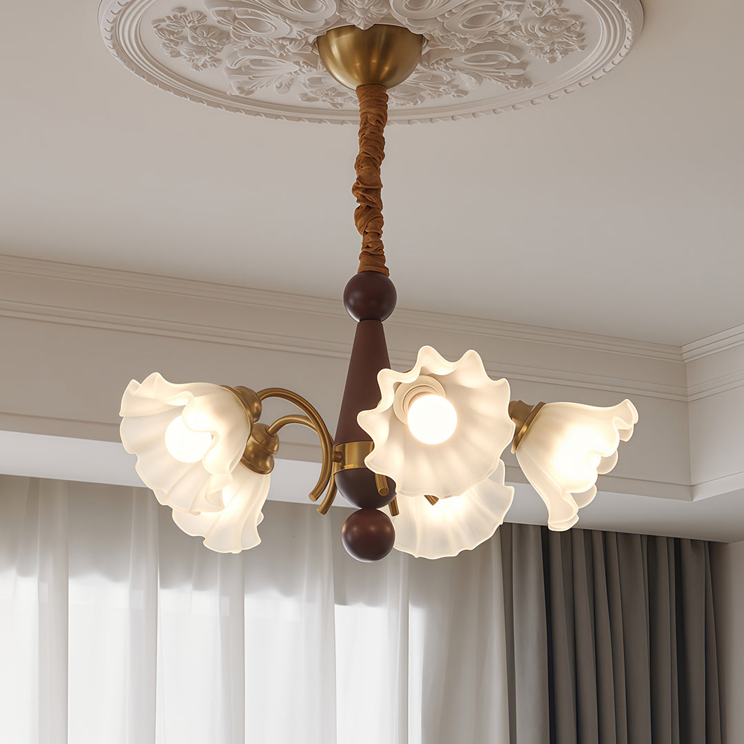 Crystal vintage chandelier brightening elegant dining space with blue curtains, ornate ceiling medallion, and classic furniture.